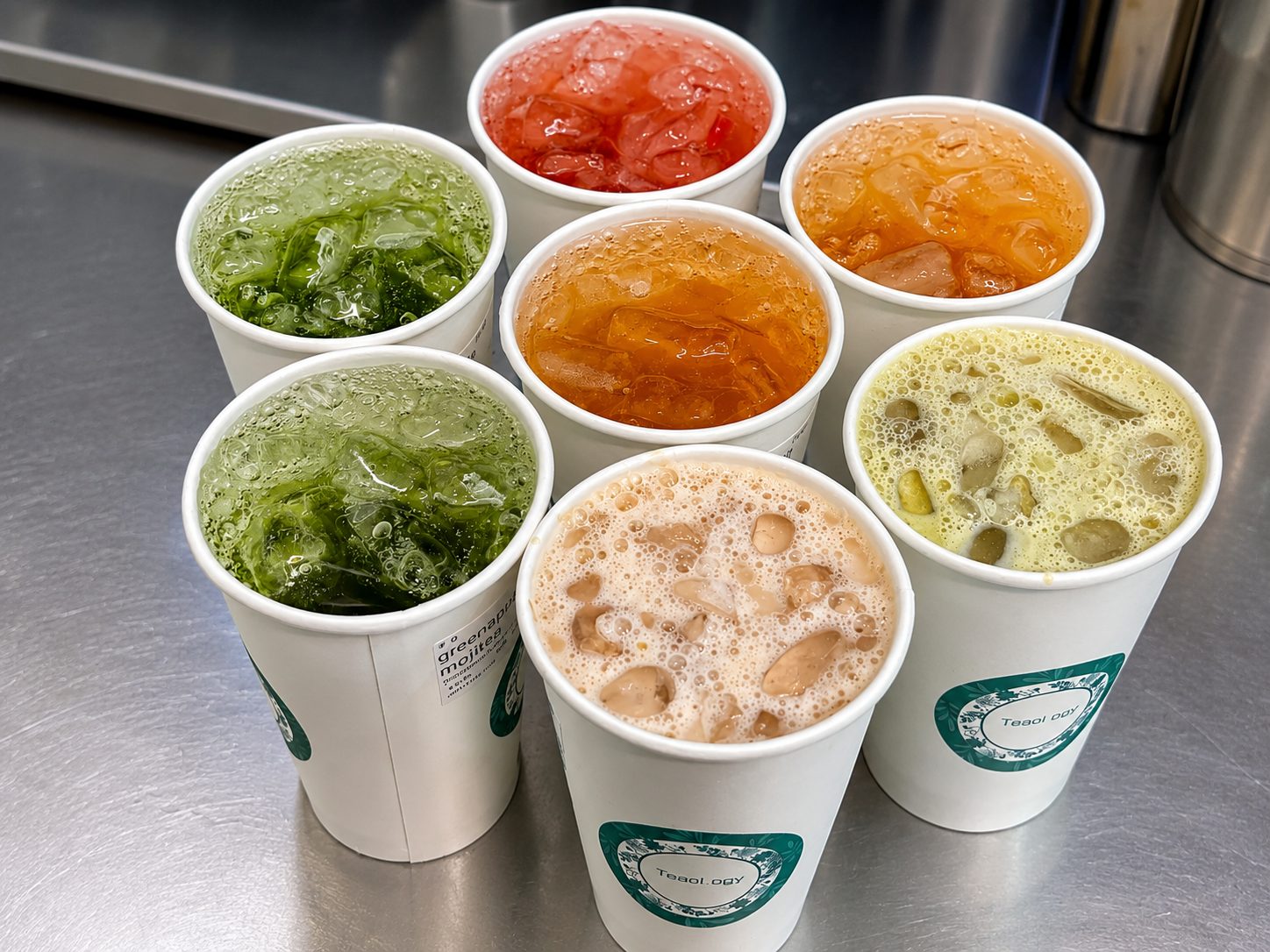 A colourful line-up of freshly made bubble teas on the counter